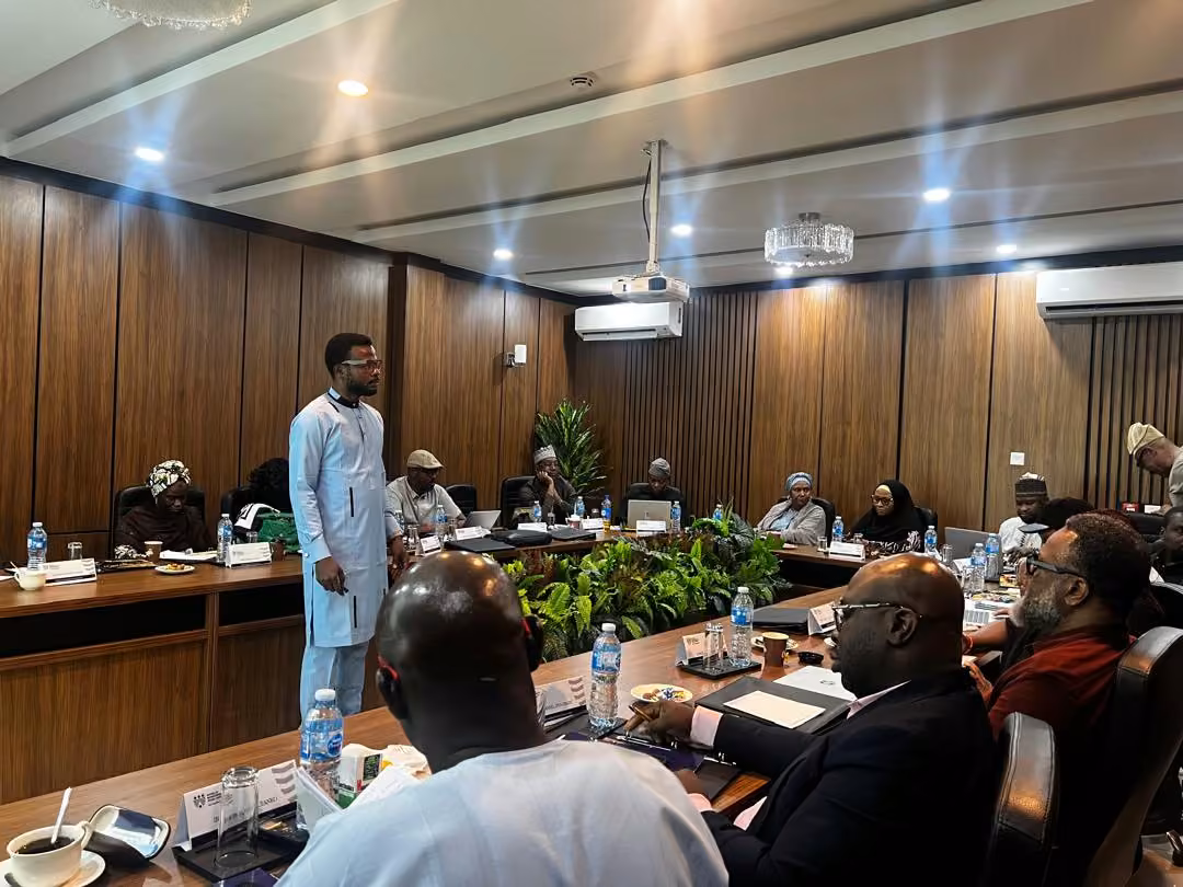 Professionals gathered around a boardroom table during a facilitated discussion